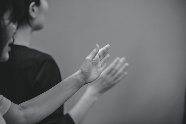 Two people clapping their hands together.