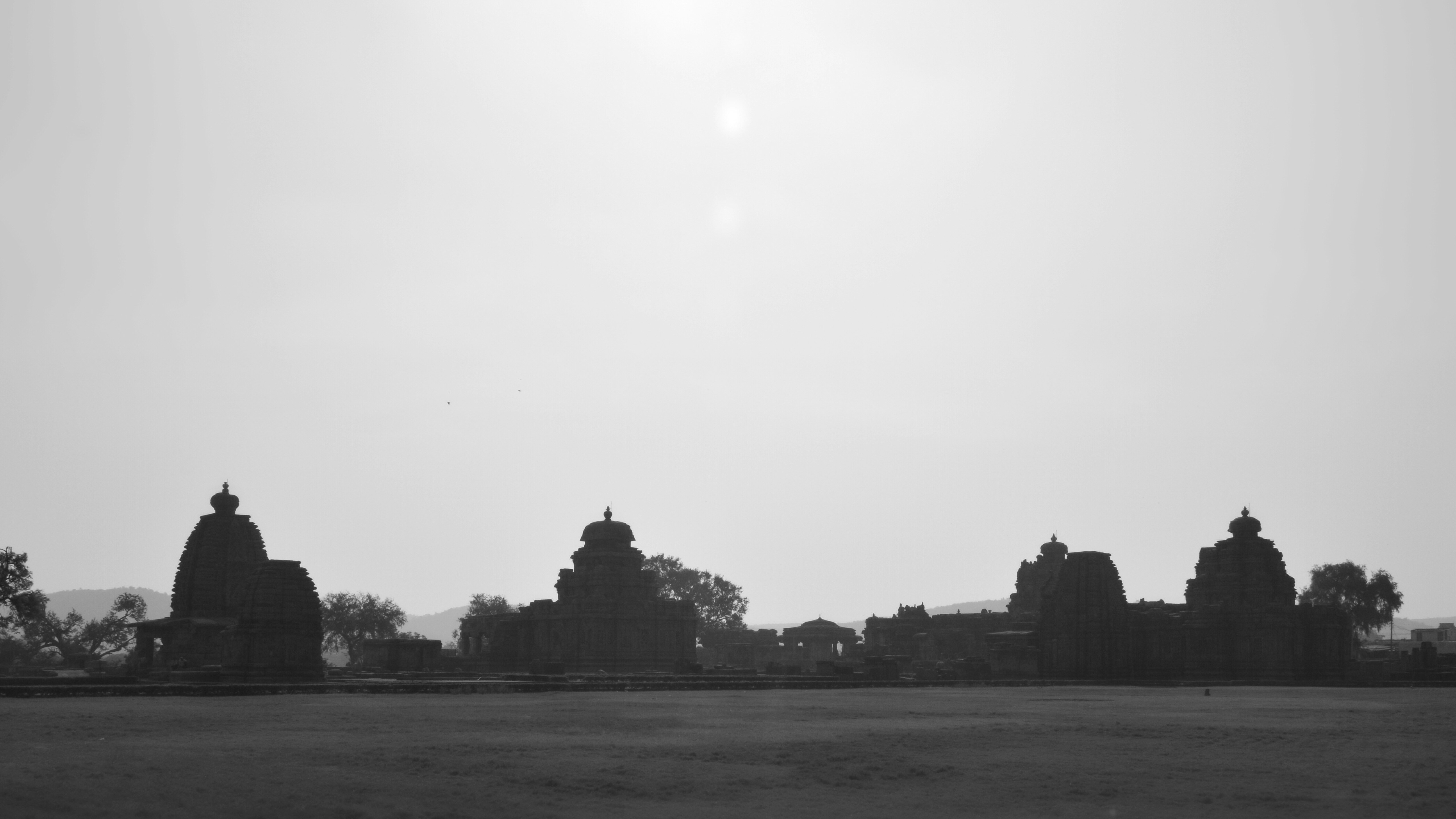 Silhouetted ancient temples against a hazy sky