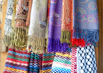 Colorful scarves and textiles displayed for sale.