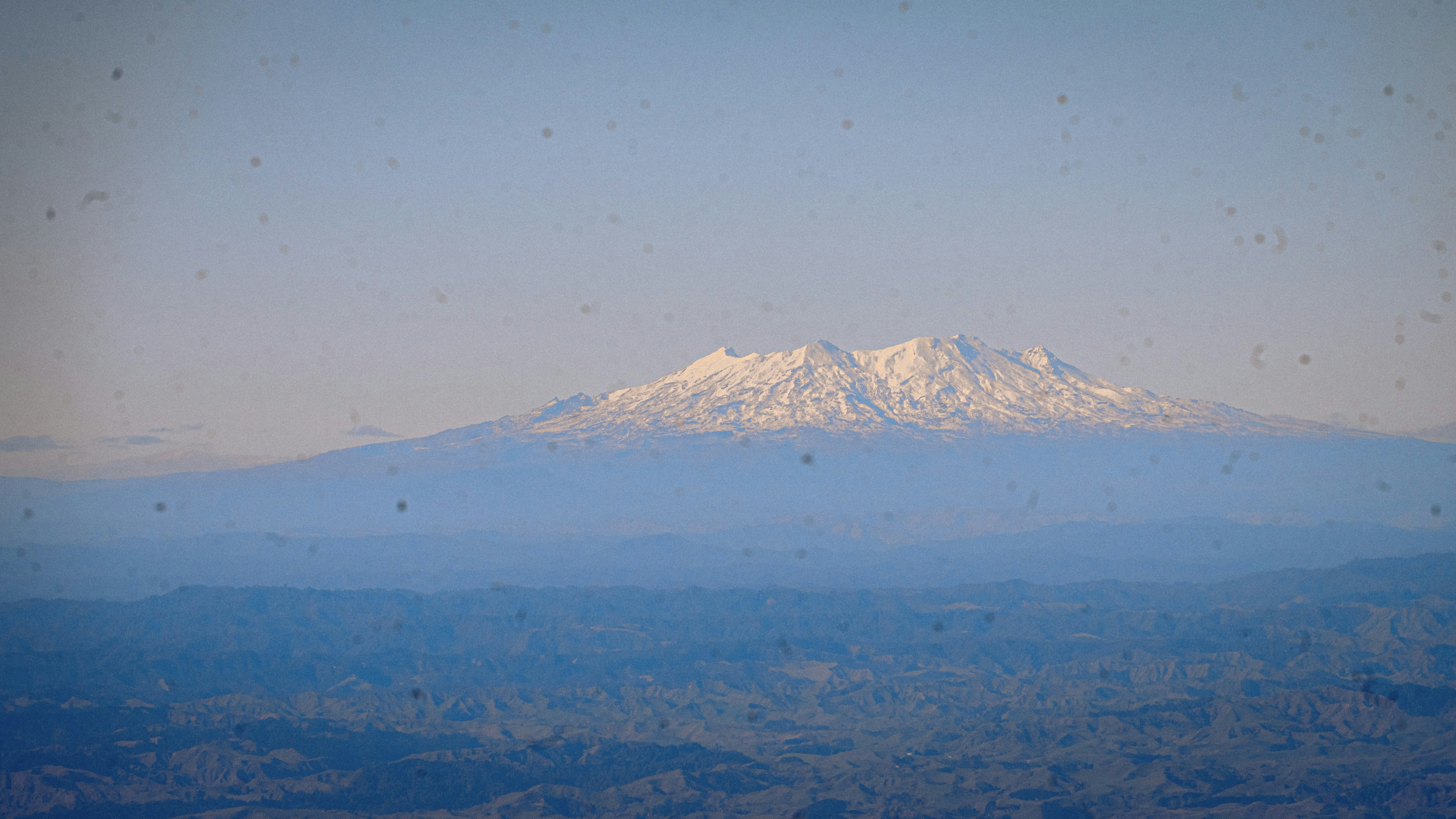 Snow-capped mountain range under a clear sky.