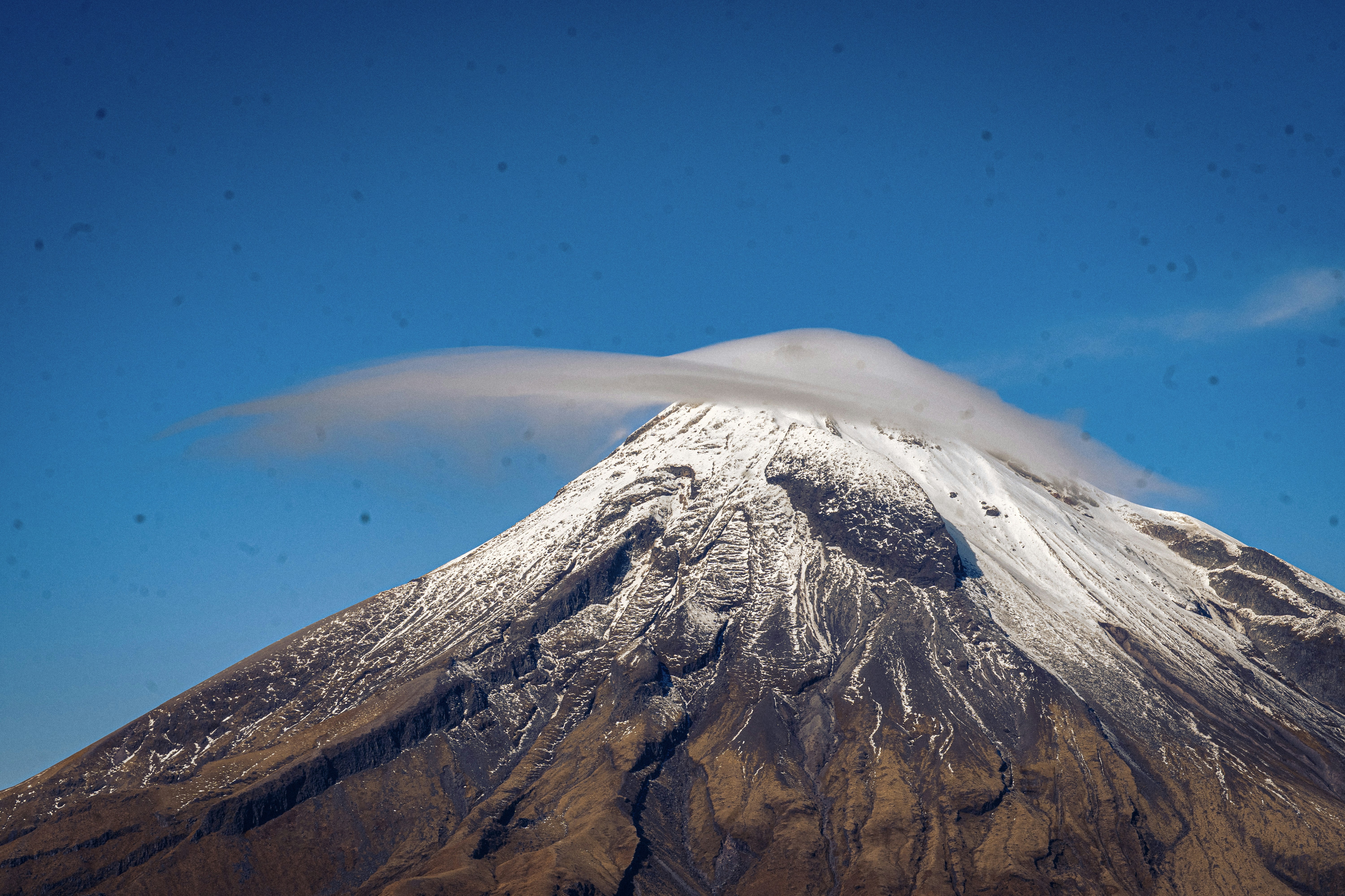 Snow-capped volcano under a clear blue sky