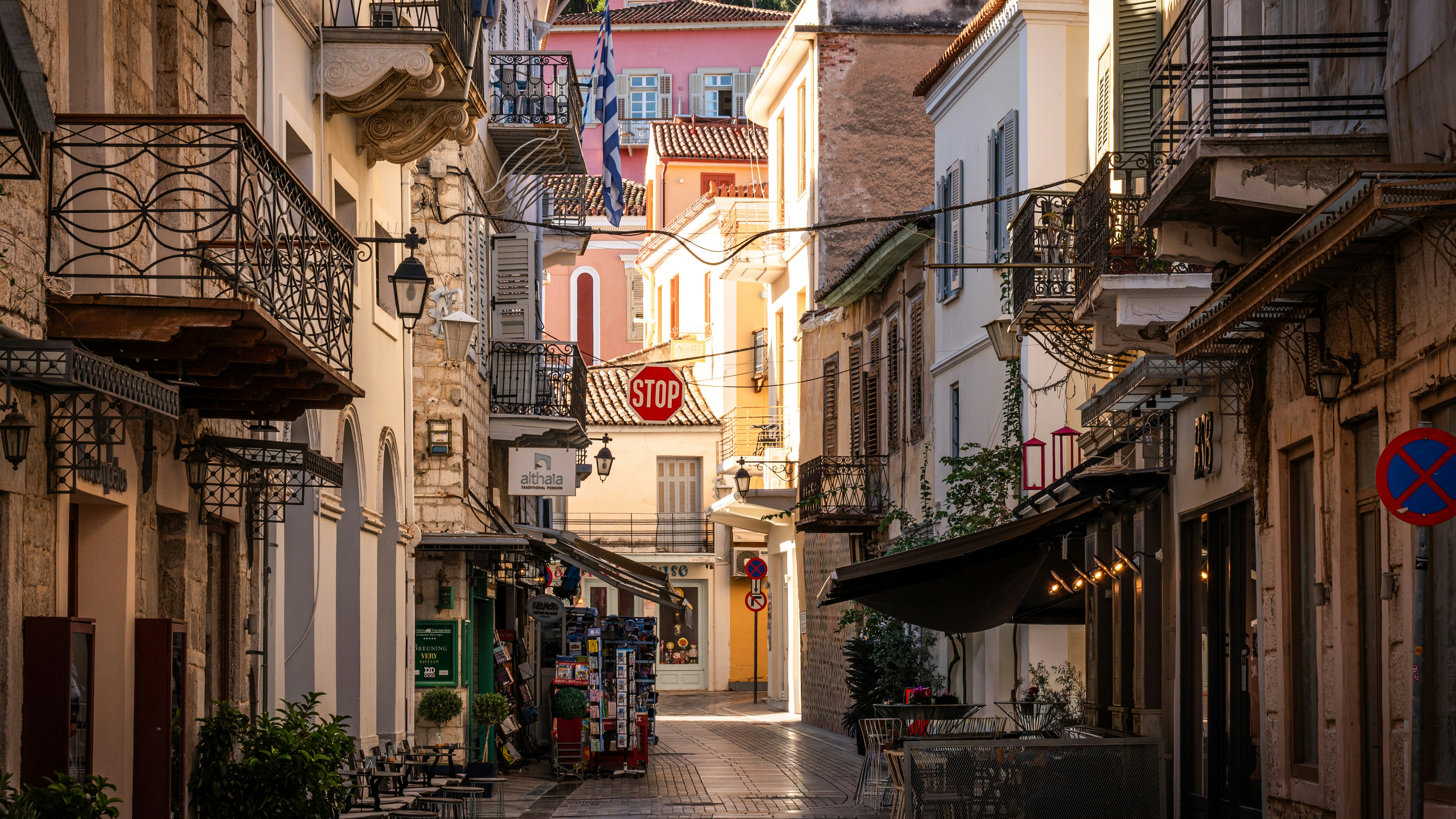 Narrow European street with shops and balconies