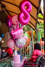 Birthday celebration with pink balloons and cake