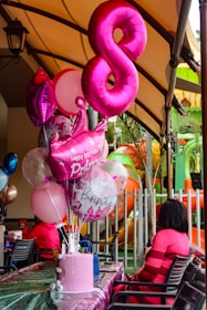 Birthday celebration with pink balloons and cake