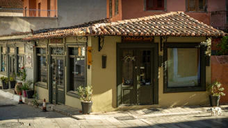 Small building with tiled roof and potted plants