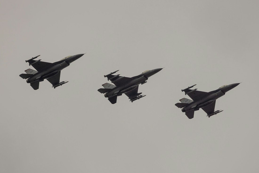 Three fighter jets flying in formation