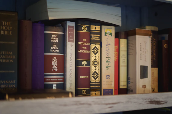 A shelf filled with various old books.