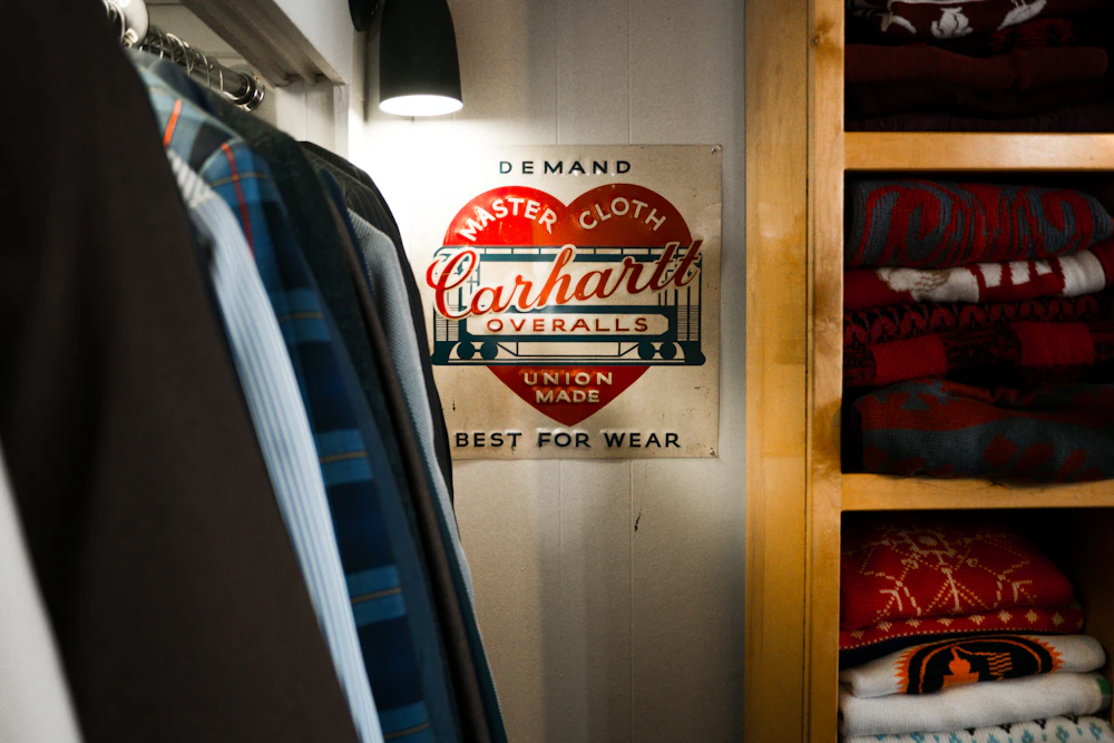 Carhartt overalls sign hanging in a closet
