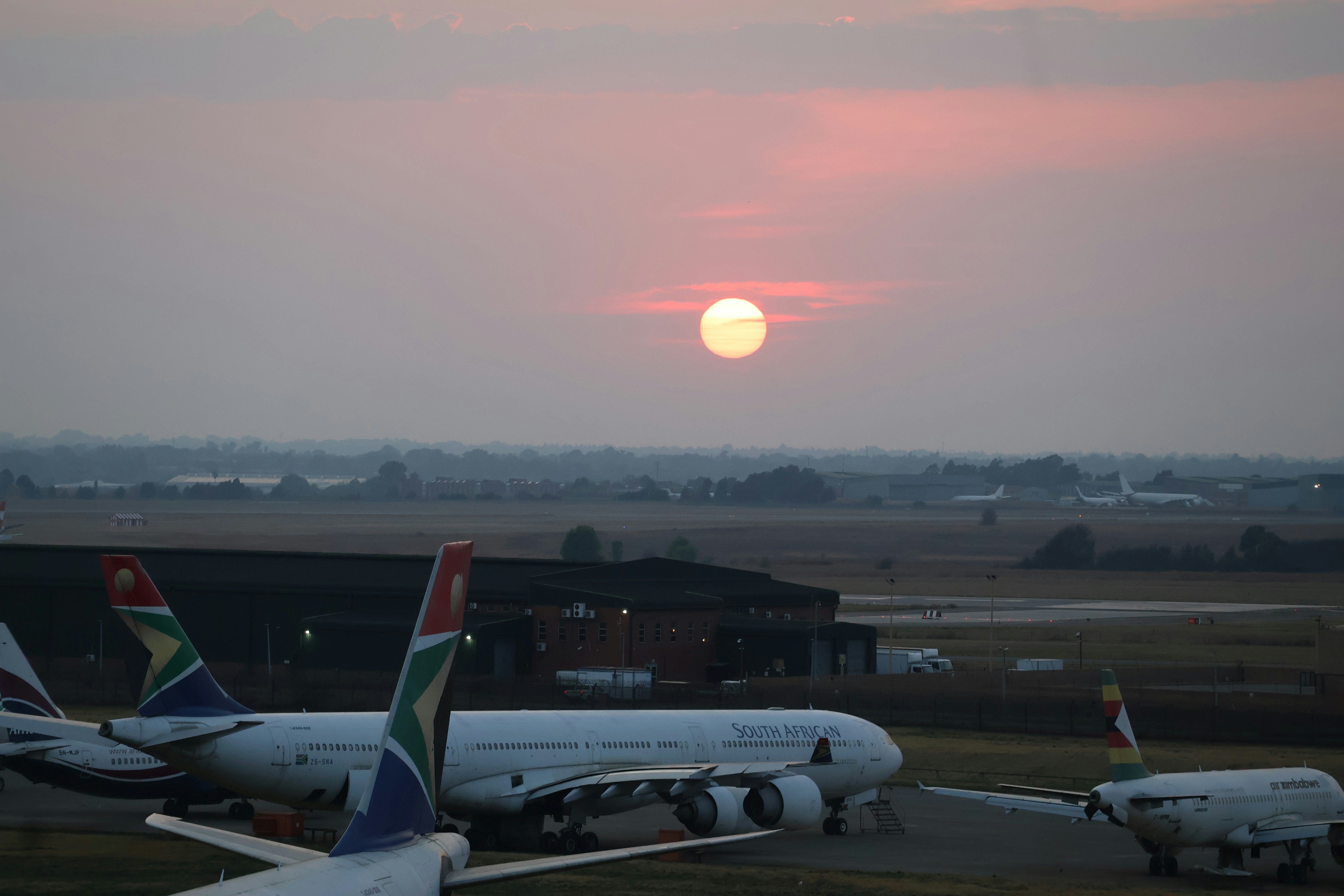 Sunrise over an airport tarmac at O.R. Tambo International Airport