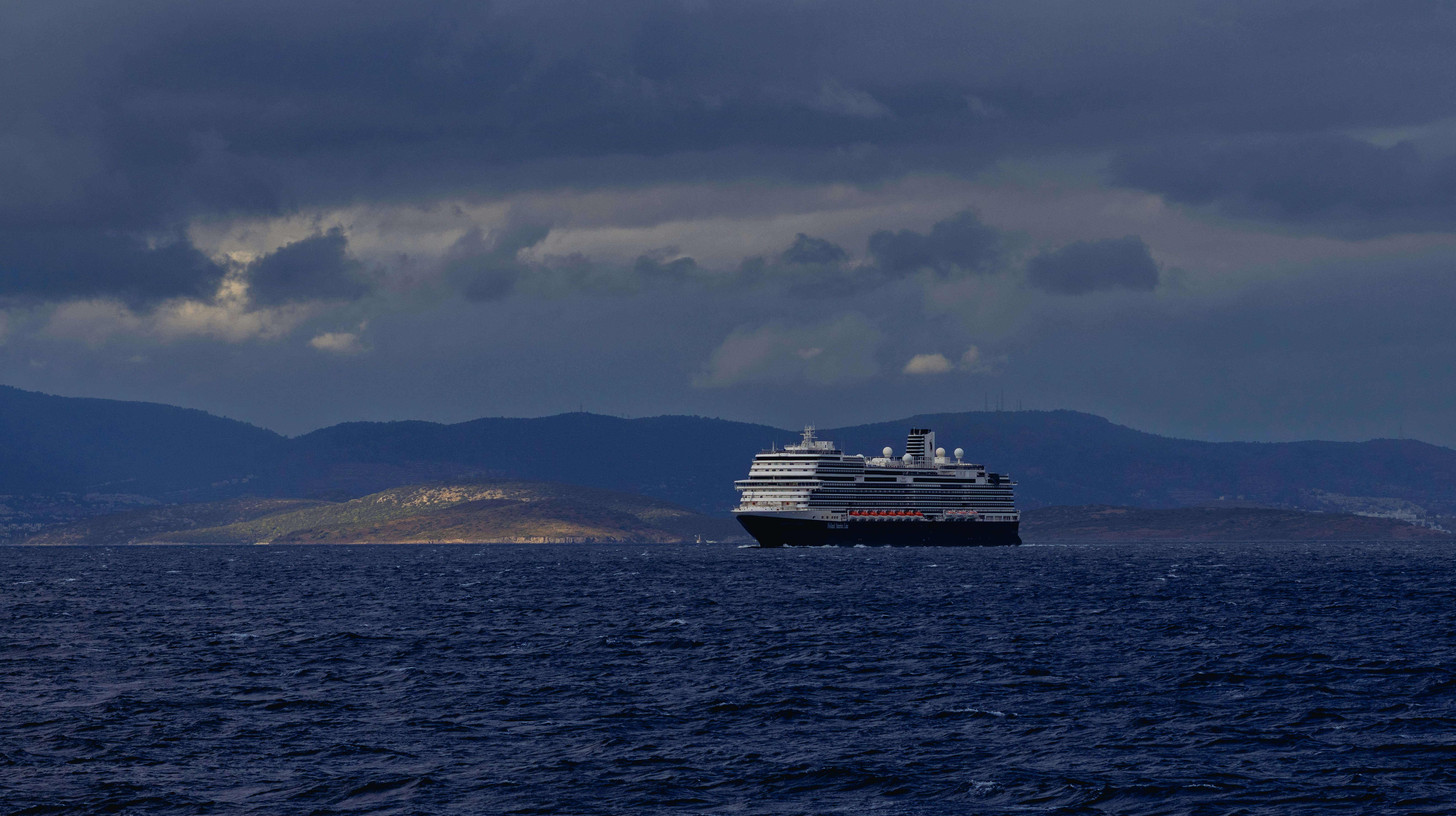 A large cruise ship sails on the ocean.
