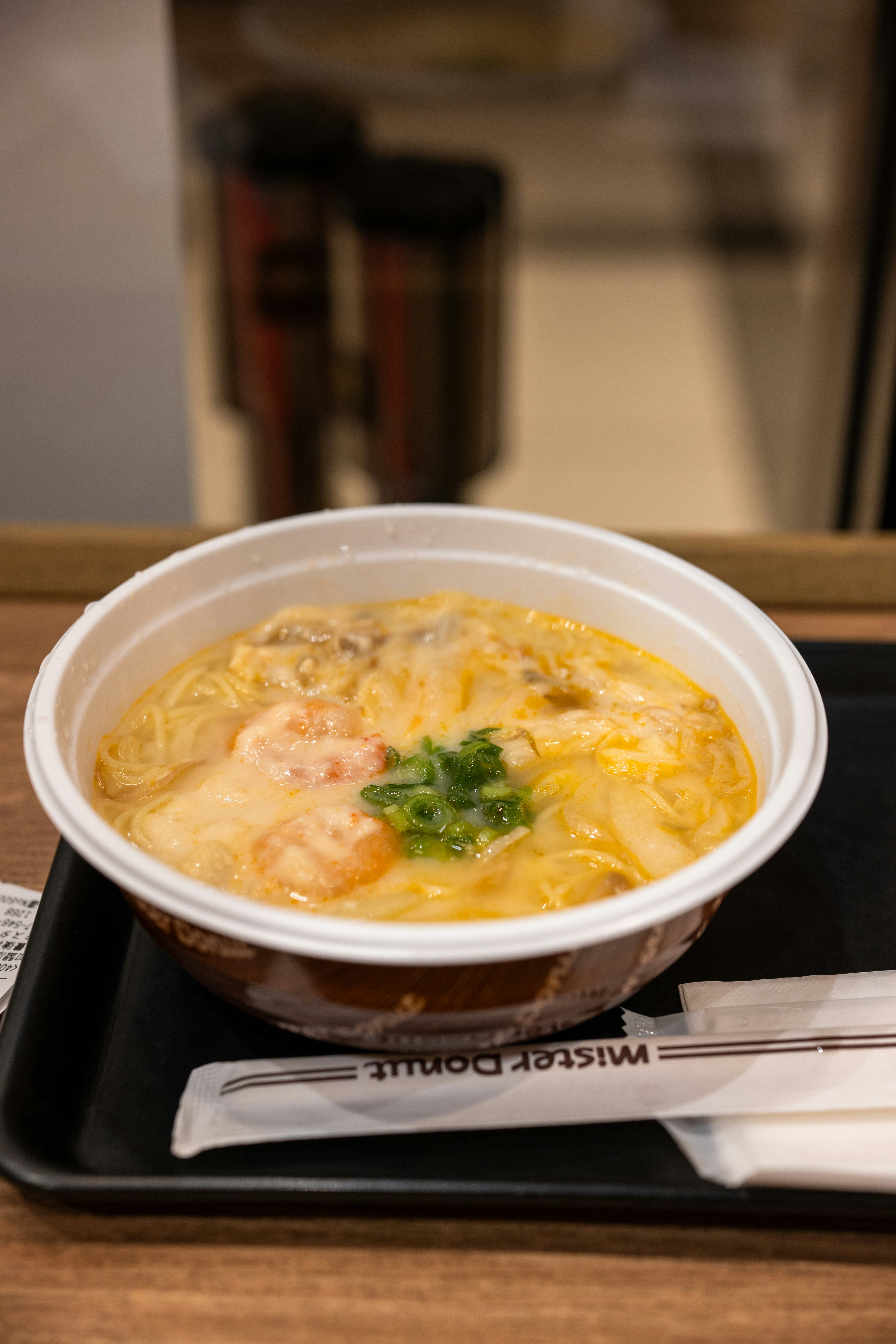 Creamy shrimp noodle soup with green onions.