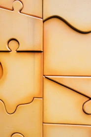Close-up of interlocking puzzle pieces with warm lighting