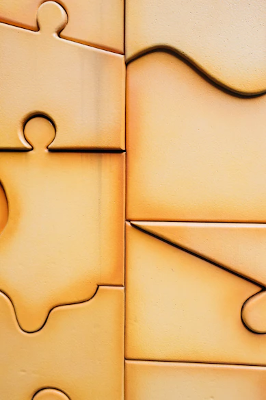Close-up of interlocking puzzle pieces with warm lighting