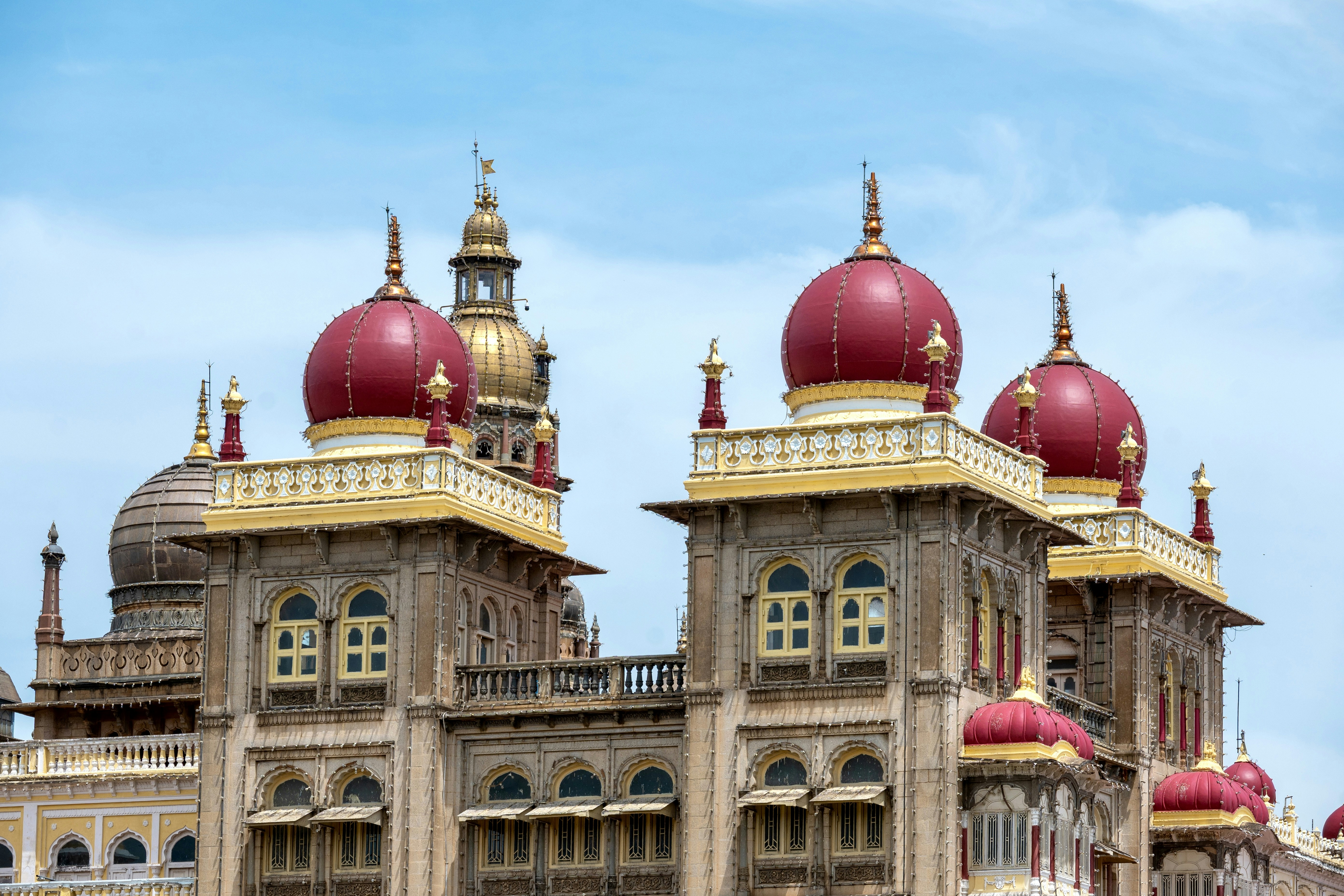 Ornate palace with red domes against blue sky