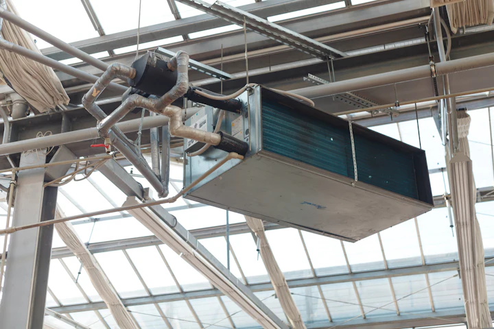 Air handling unit and pipework being installed at high level in a building