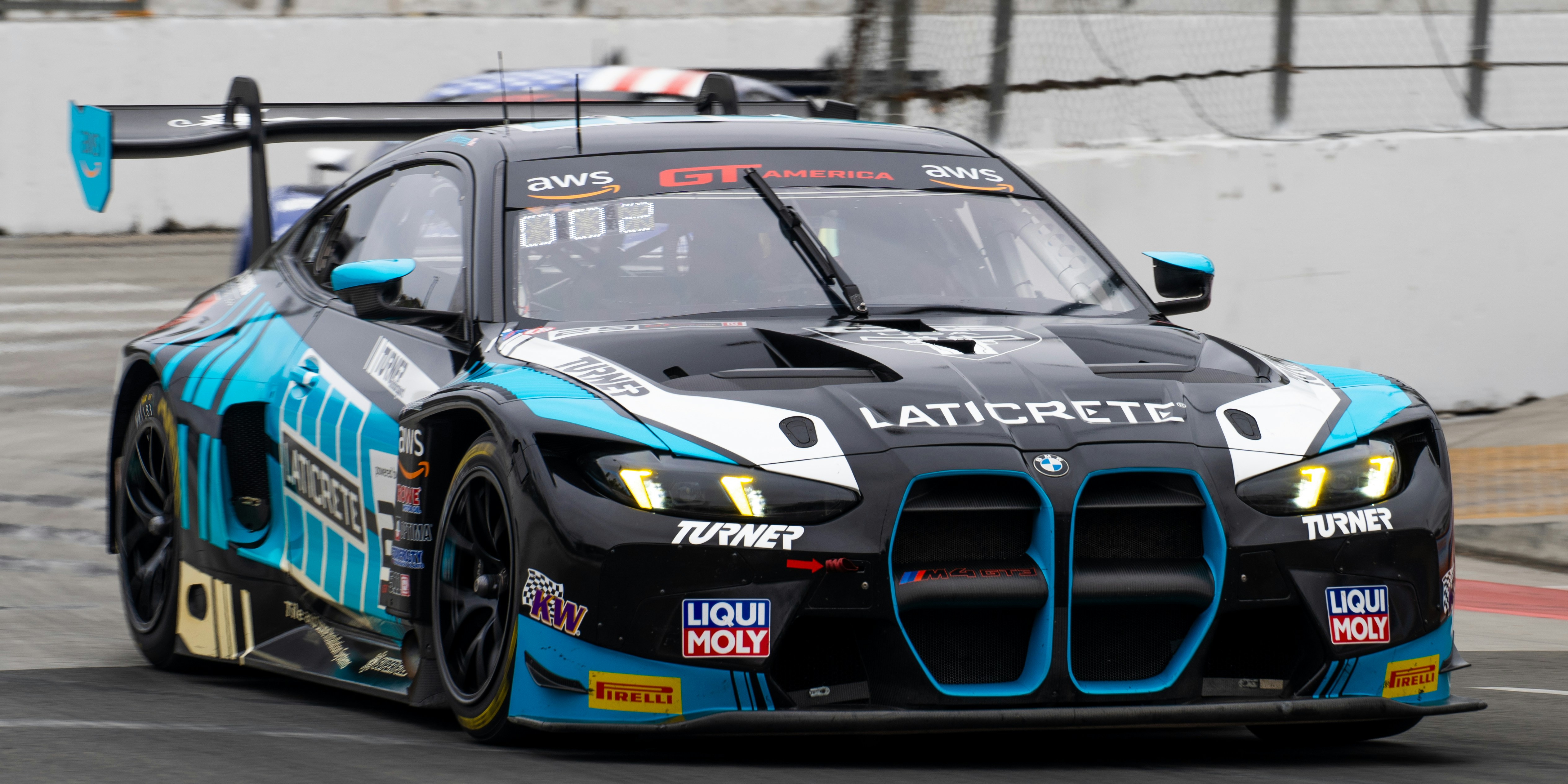 A black and blue racing car on a track