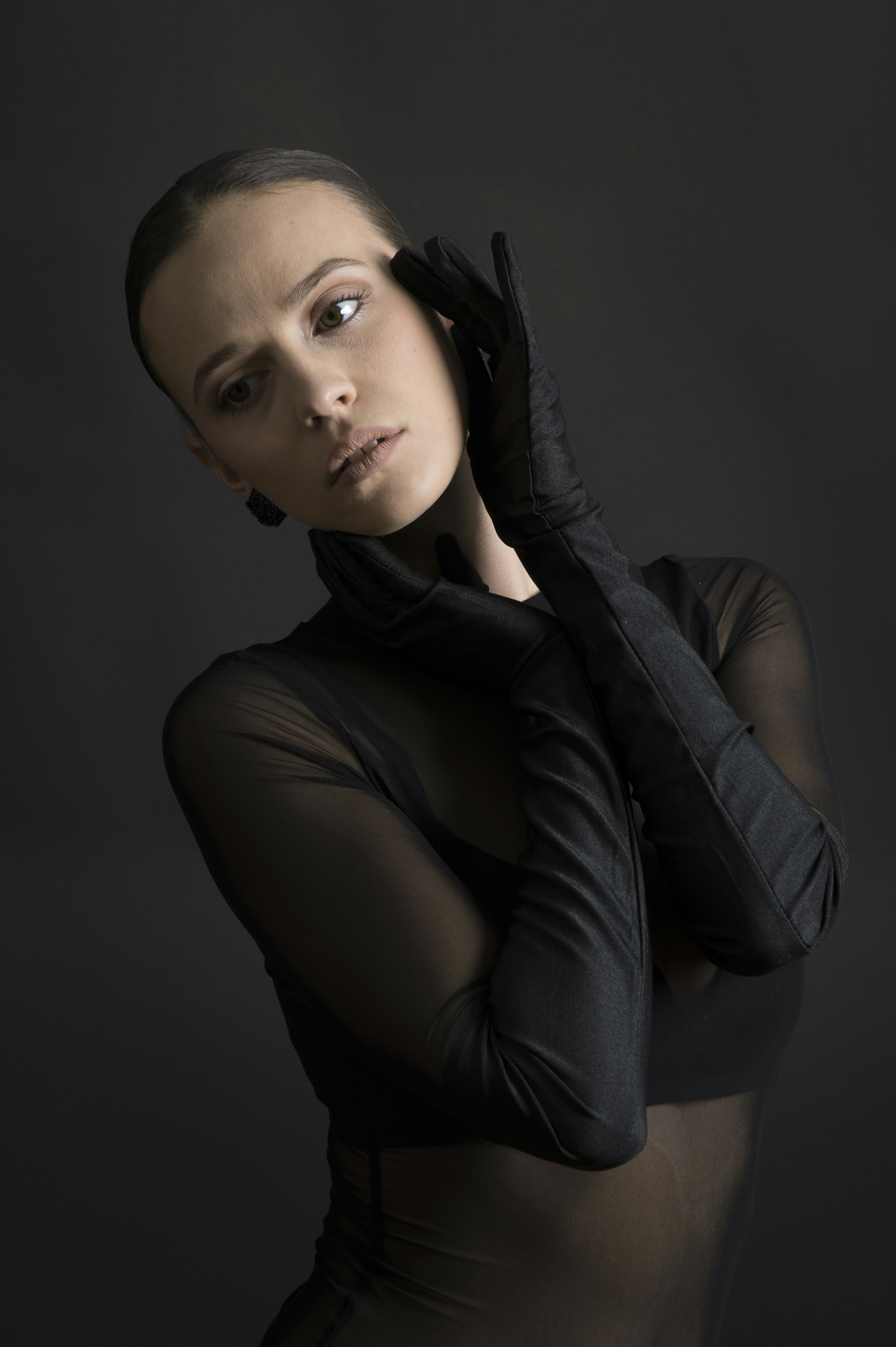 Woman in sheer black top and gloves