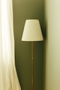 A tall floor lamp with a white shade.