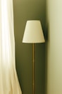 A tall floor lamp with a white shade.