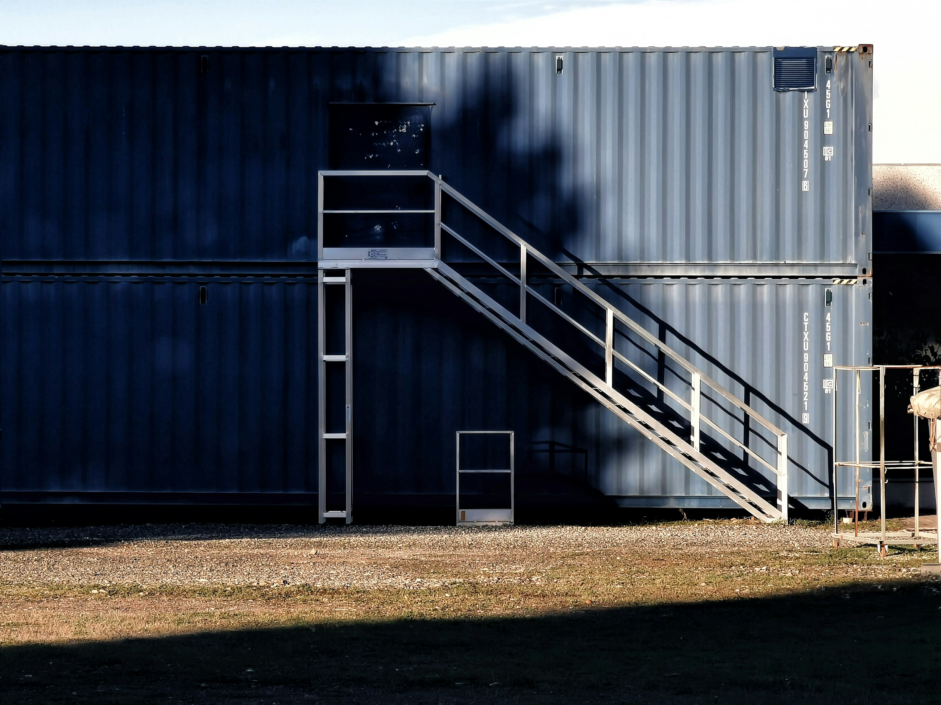 Blue shipping containers modular with metal stairs