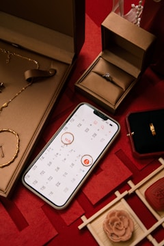 Jewelry, engagement ring, and calendar on red background