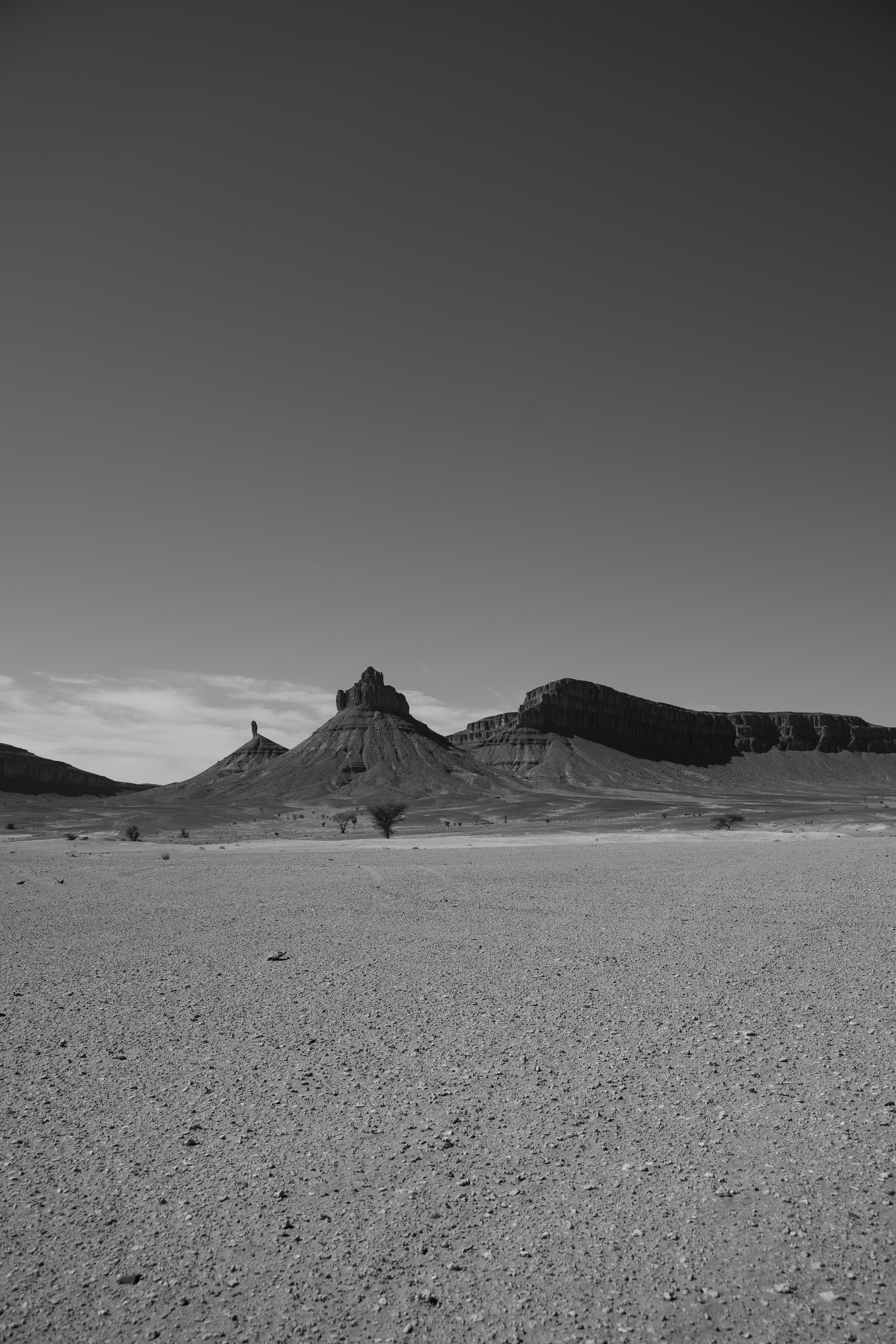 Arid desert landscape with rock formations under sky