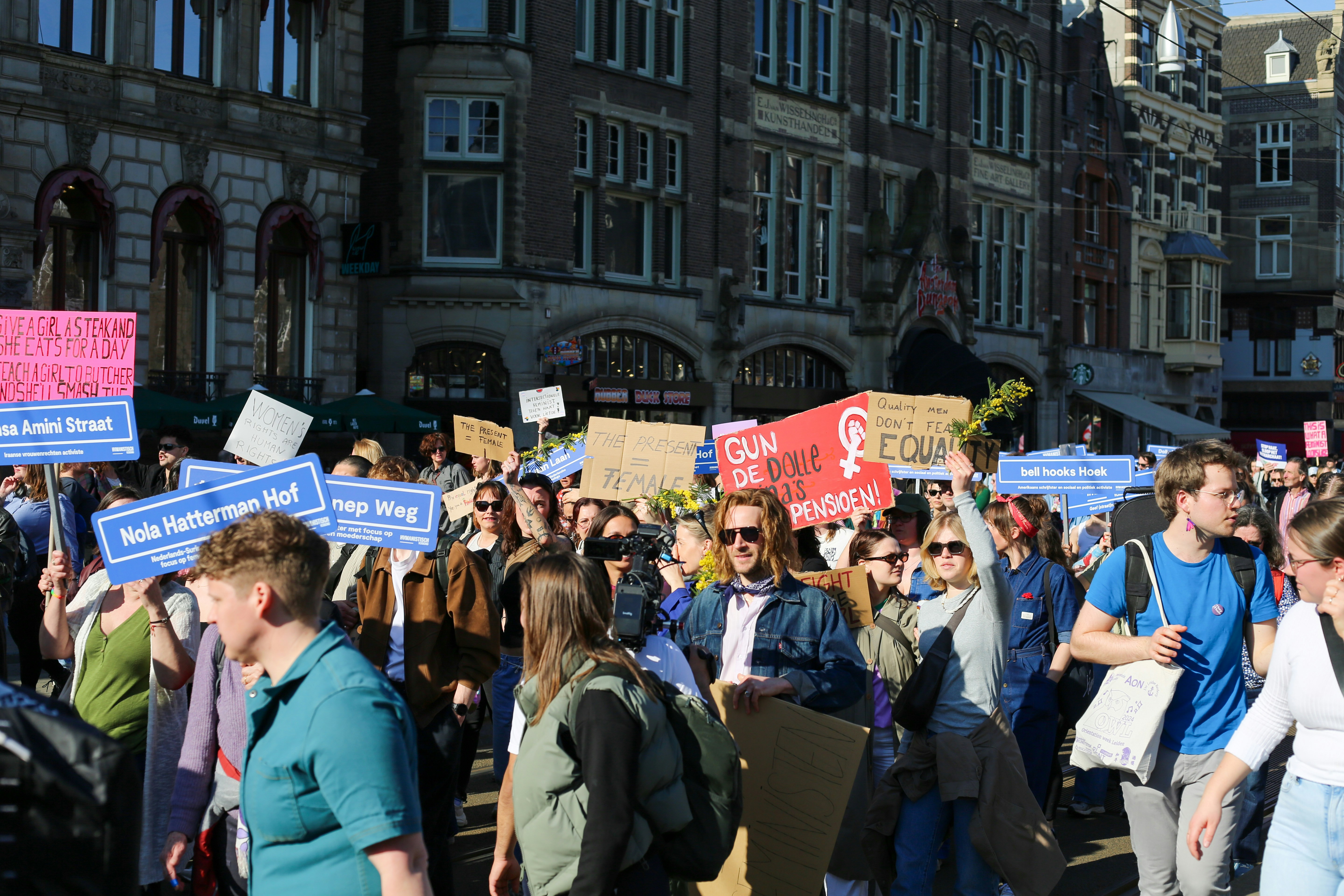Crowd of people holding signs at a protest.
