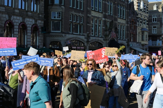 Crowd of people holding signs at a protest.