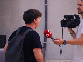 A person being interviewed with a microphone and camera