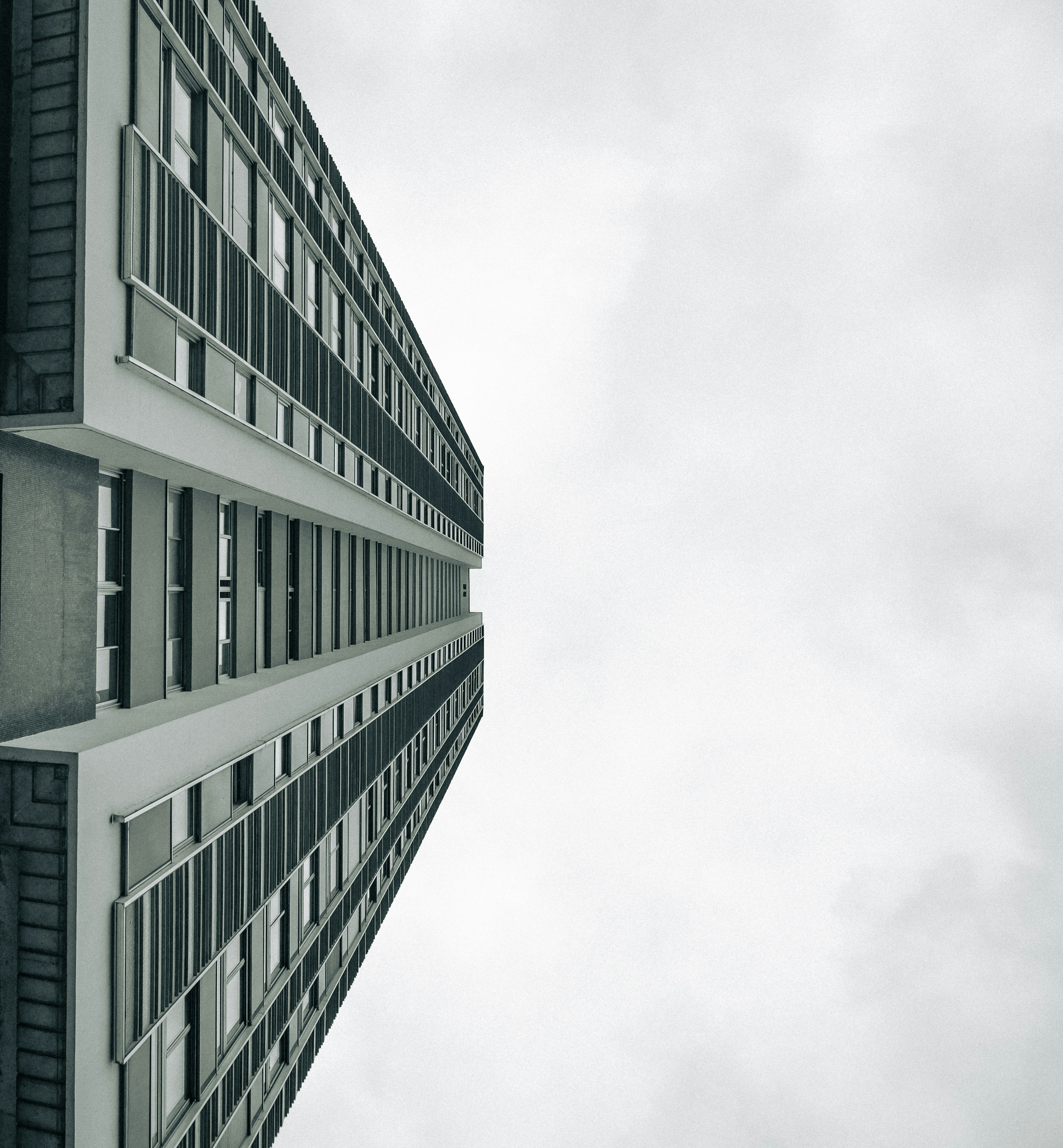 Tall modern building against a cloudy sky