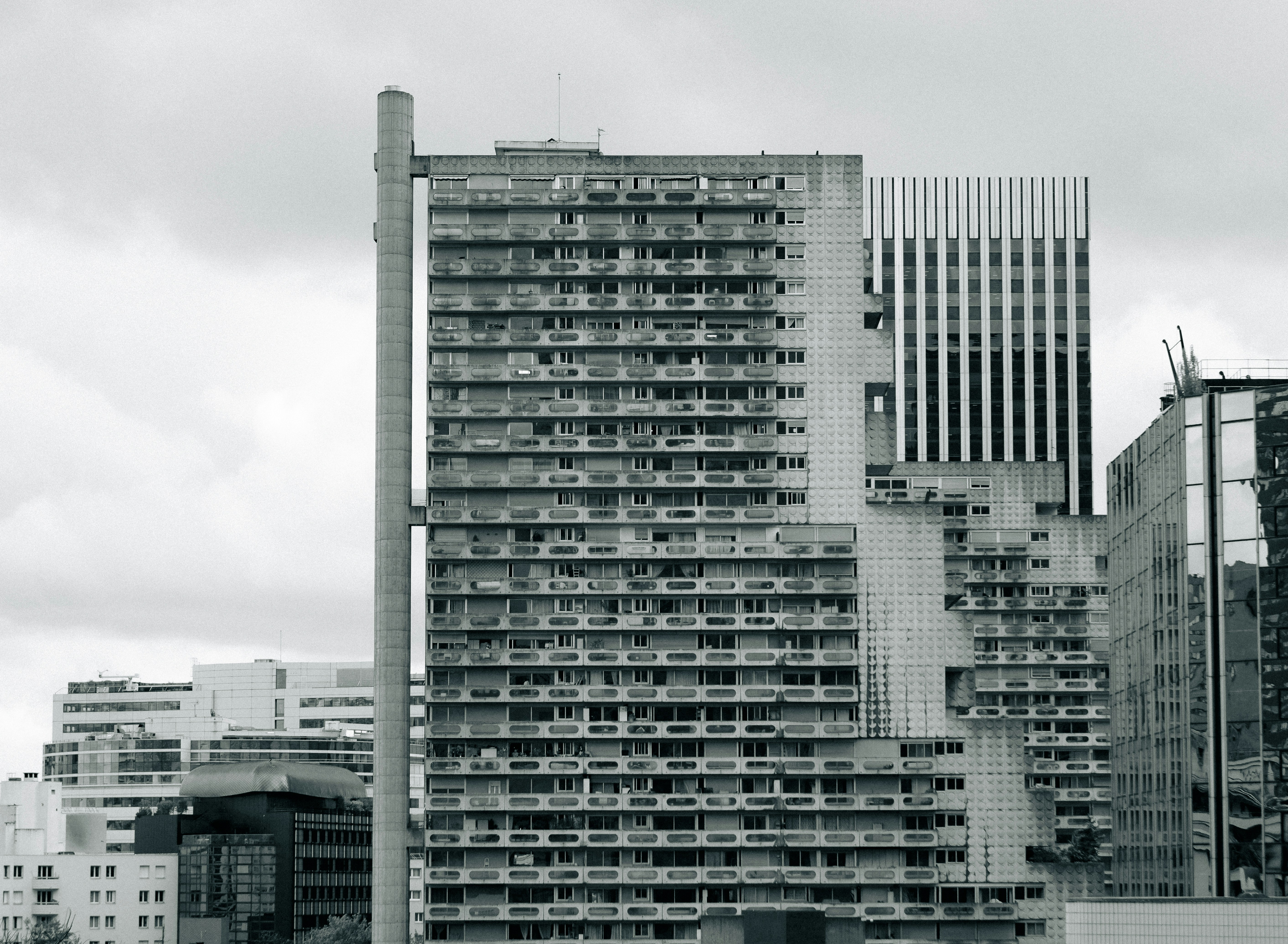 Tall apartment buildings against a cloudy sky