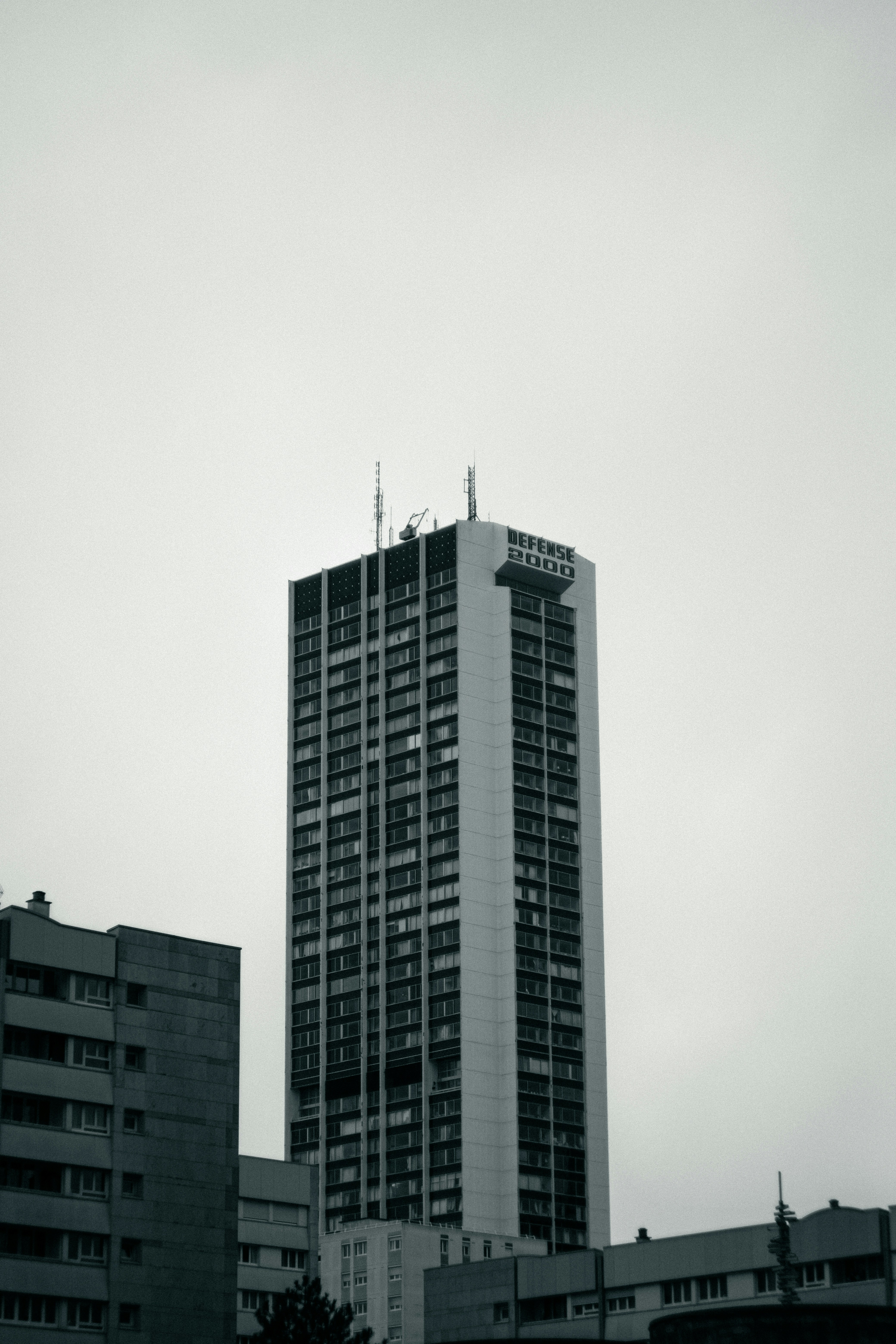 Tall modern skyscraper against a cloudy sky.