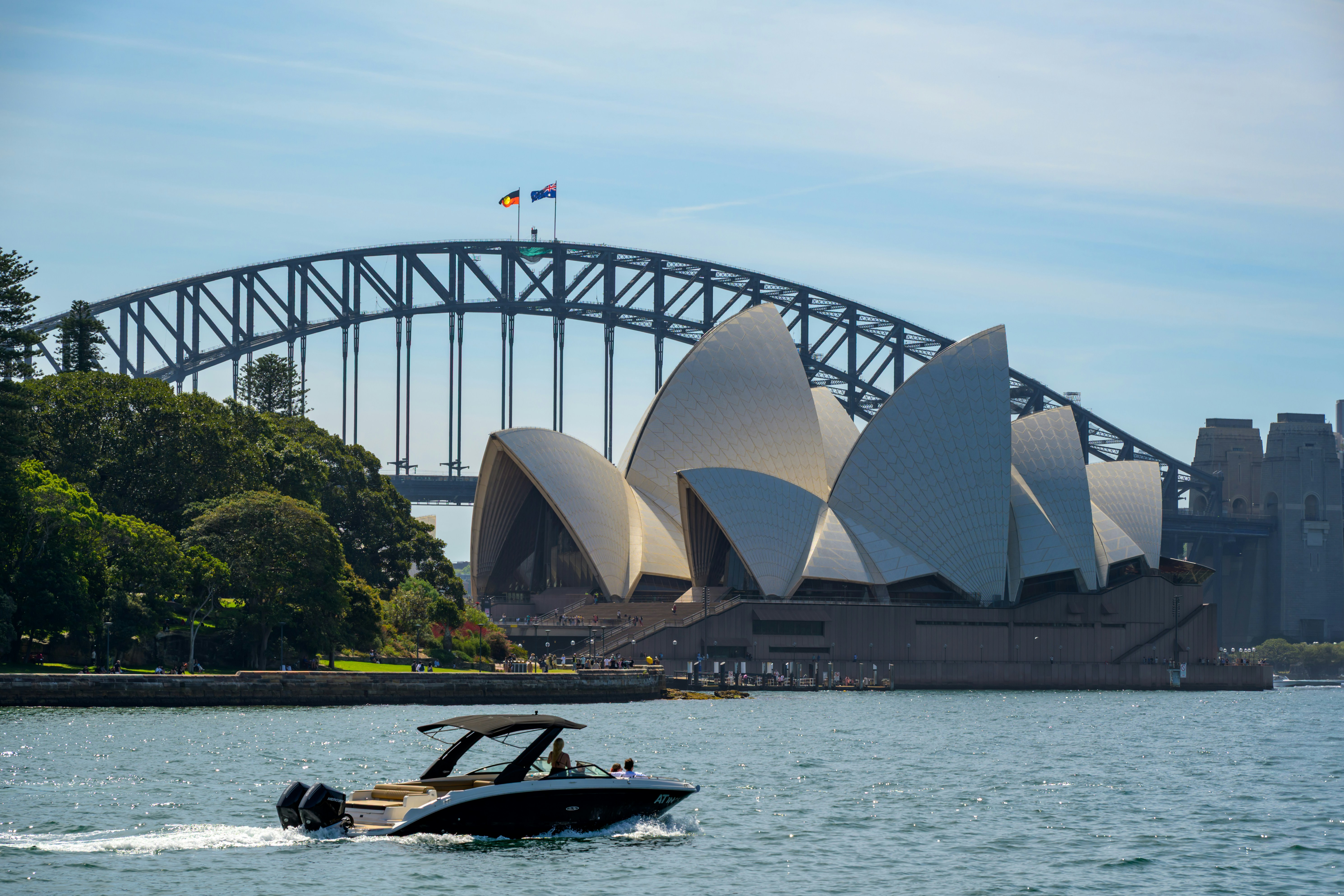 Sydney opera house and harbour bridge with boat.