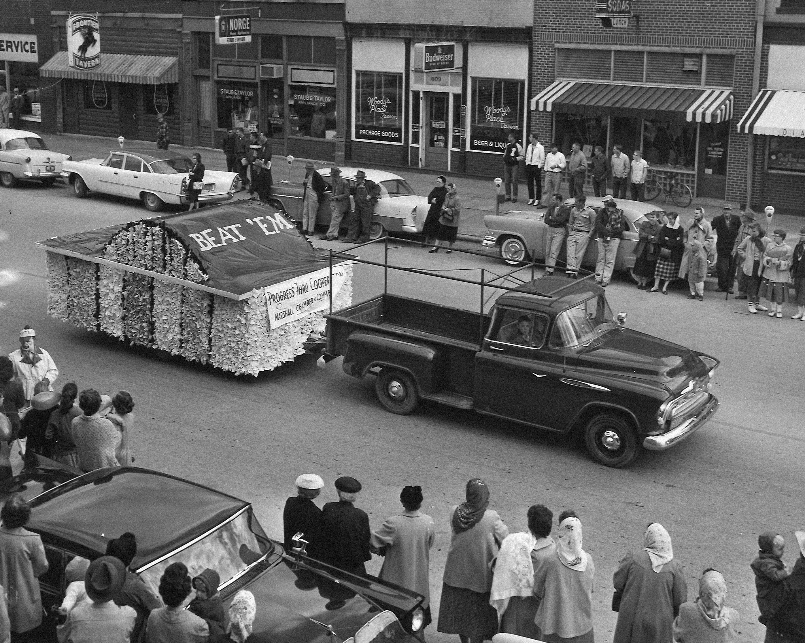 A parade float pulled by a truck on a street.