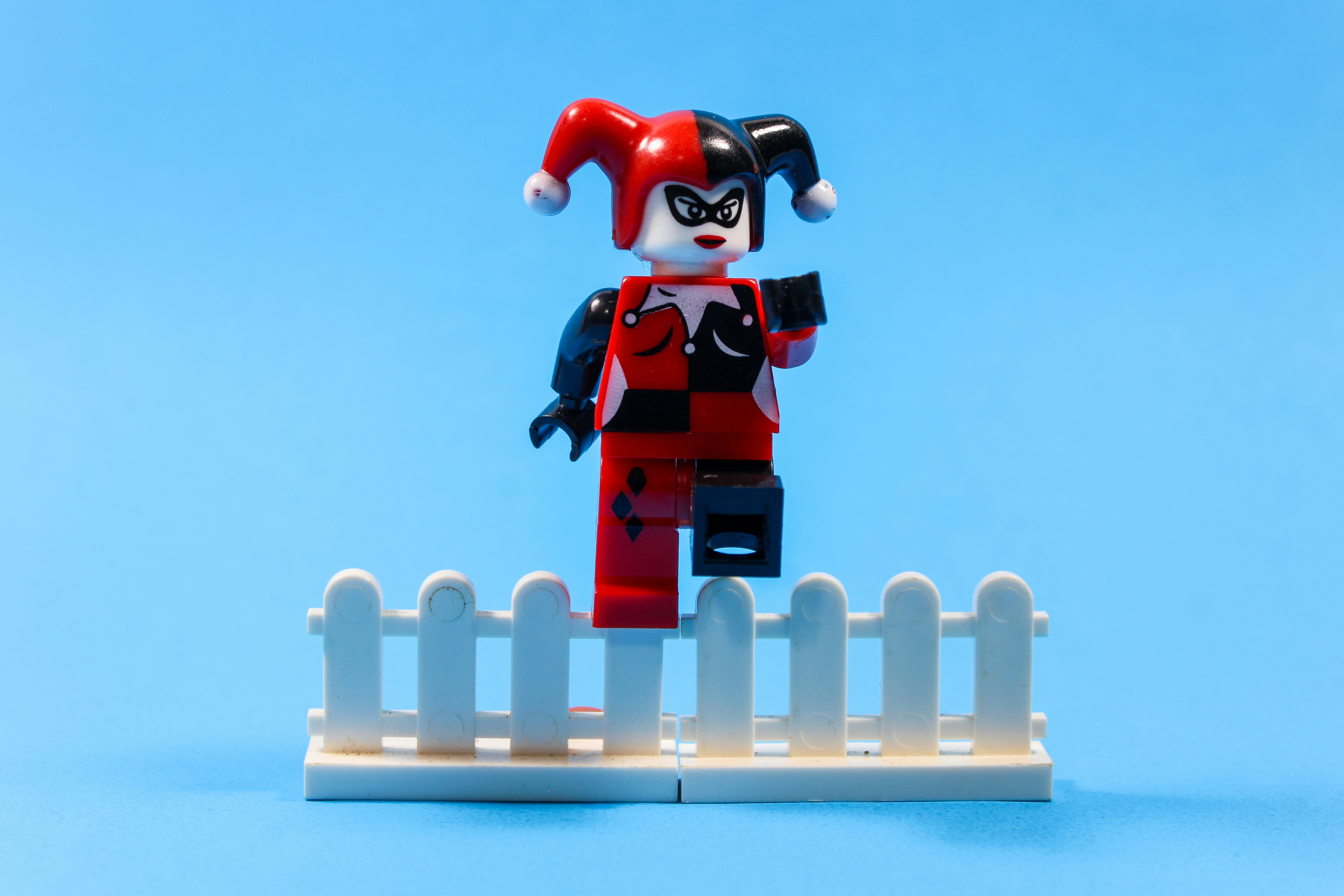 A character made of colorful building blocks, holding a creation.