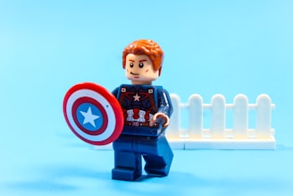 Captain america lego figure with shield on blue background