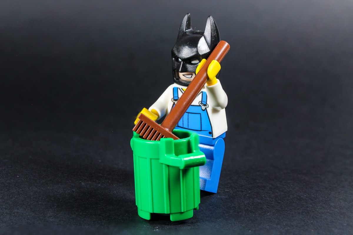 LEGO Batman cleaning a trash can