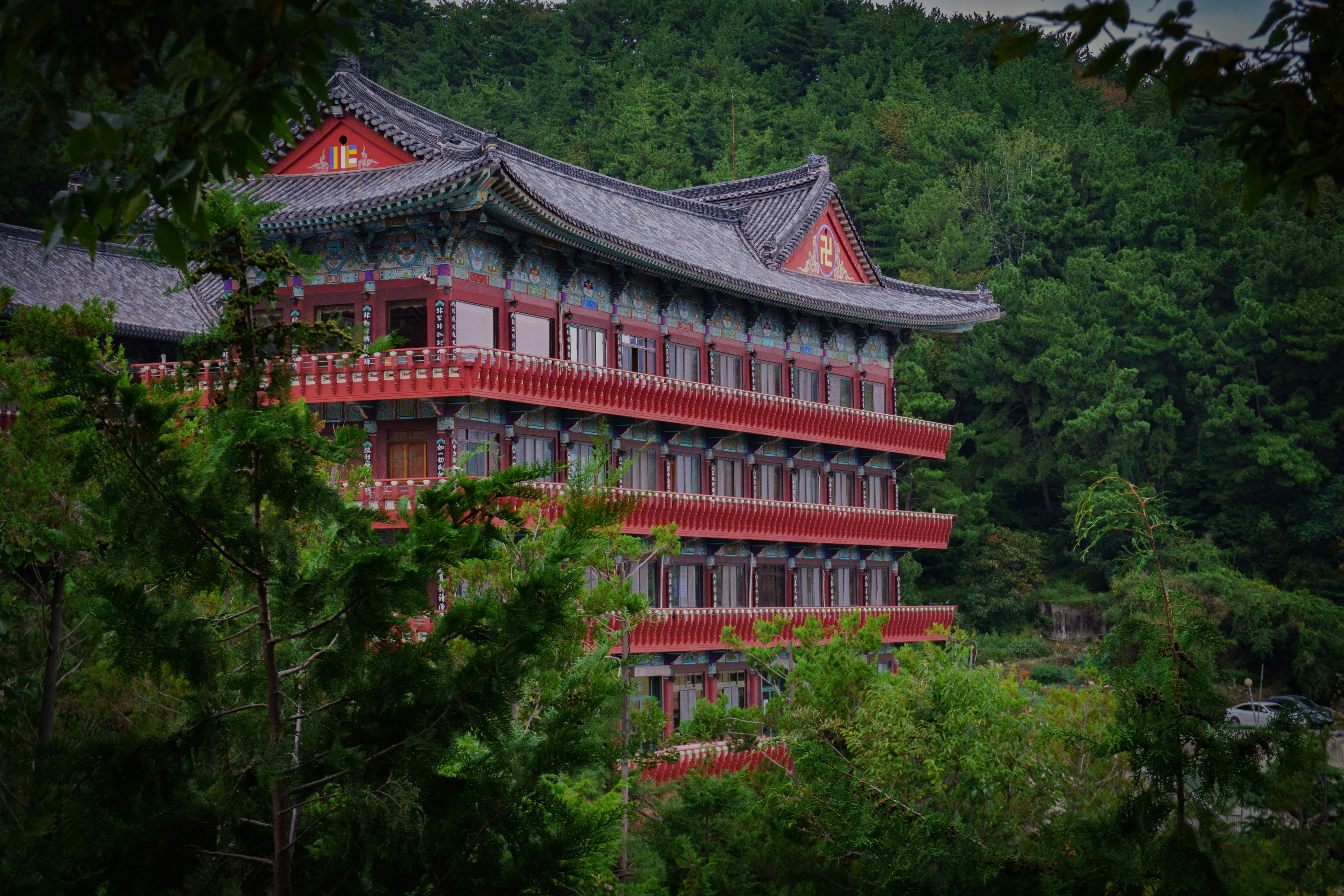 Traditional korean temple nestled in lush green mountains.