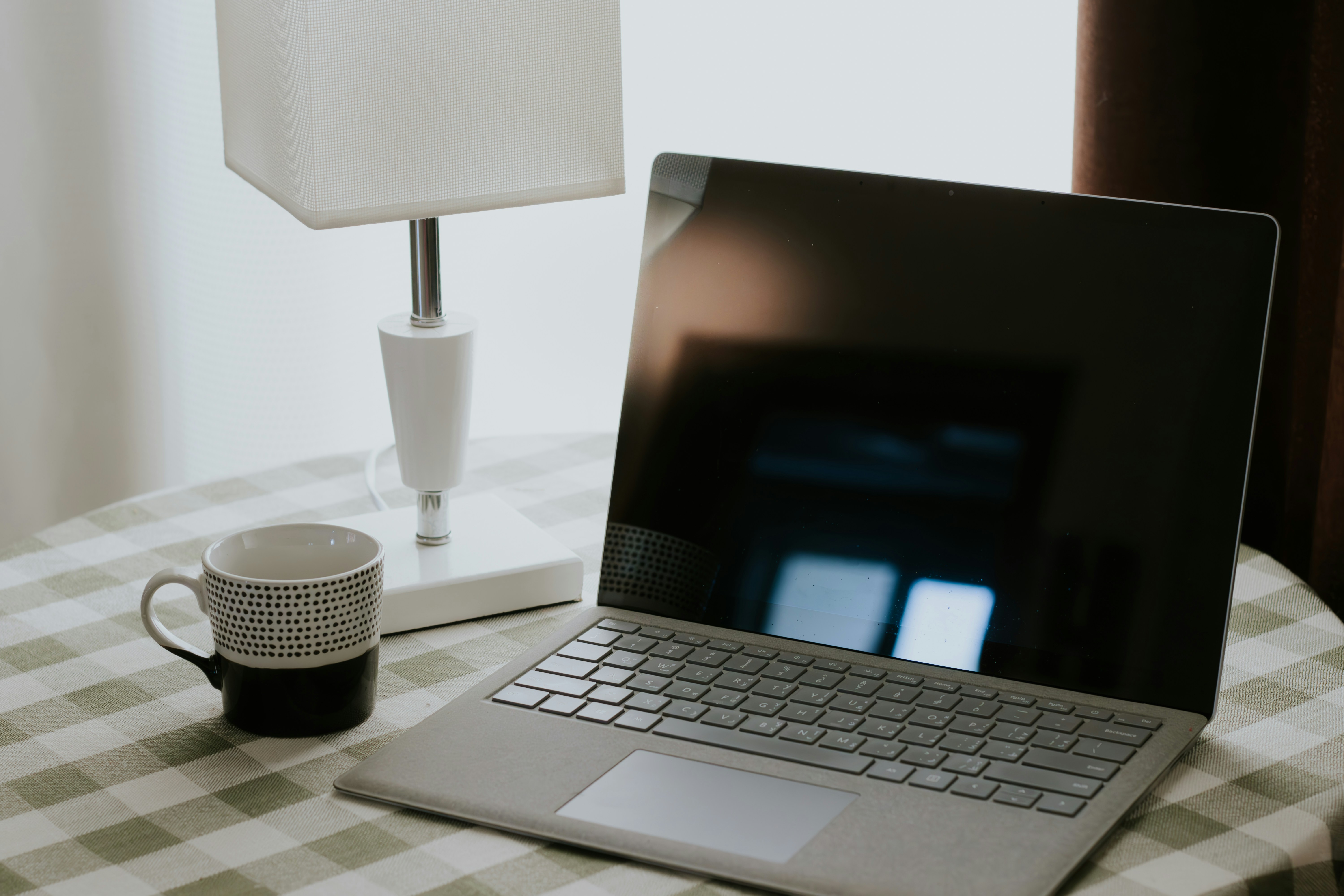 Laptop, mug and lamp setup