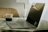 Laptop and coffee cup on a checkered tablecloth