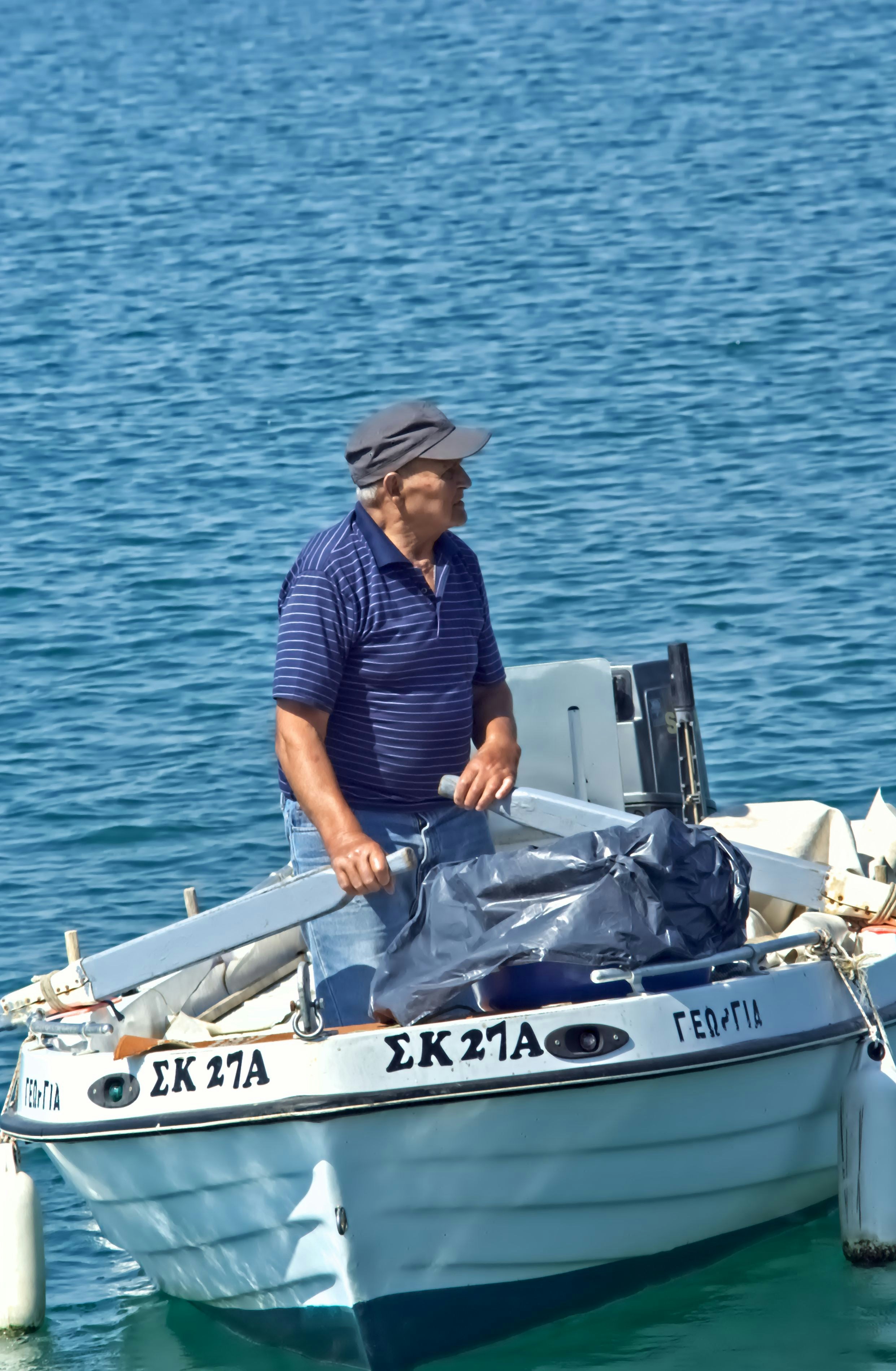 Man in a boat looking out at the water