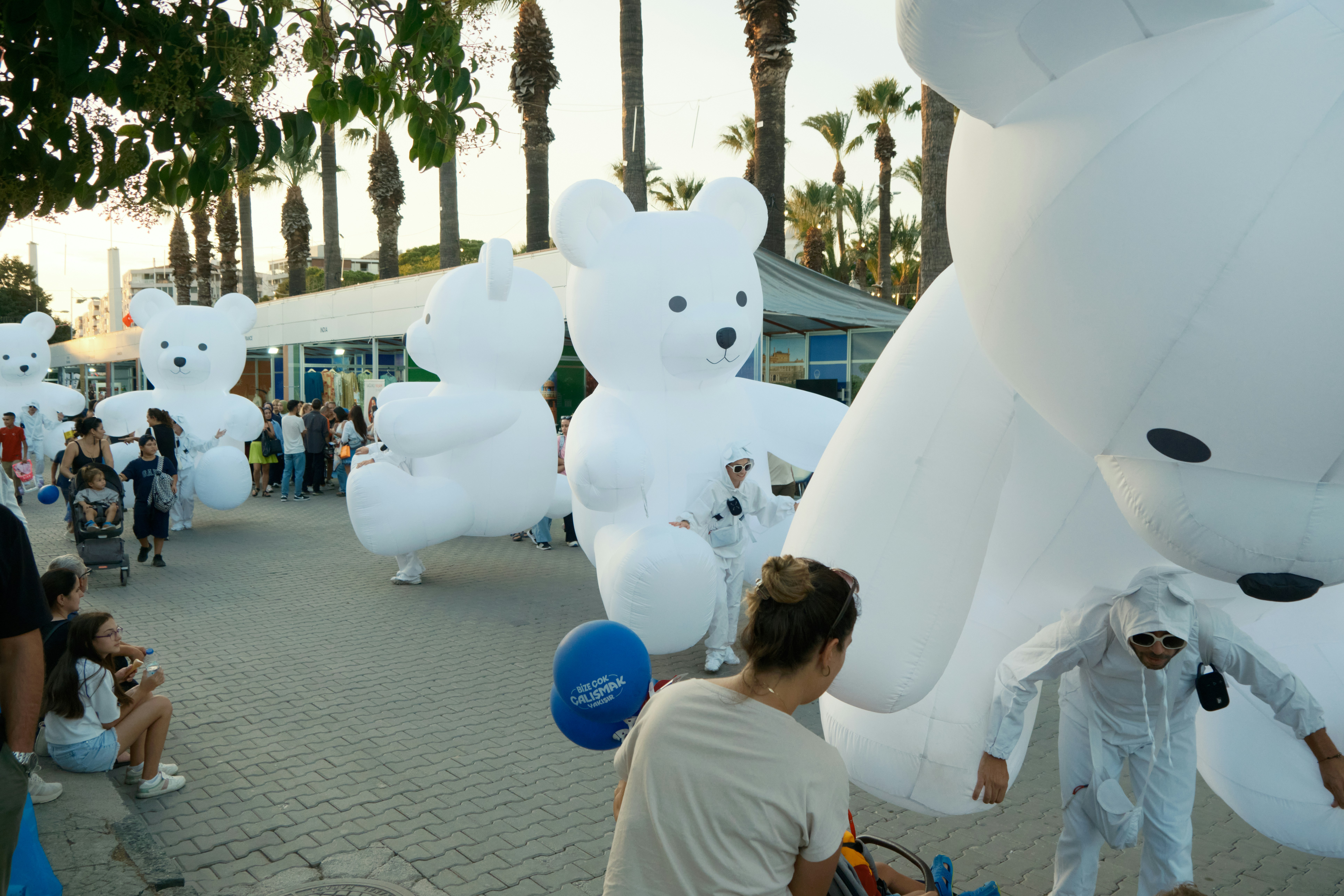 Giant inflatable white teddy bears at an outdoor event.