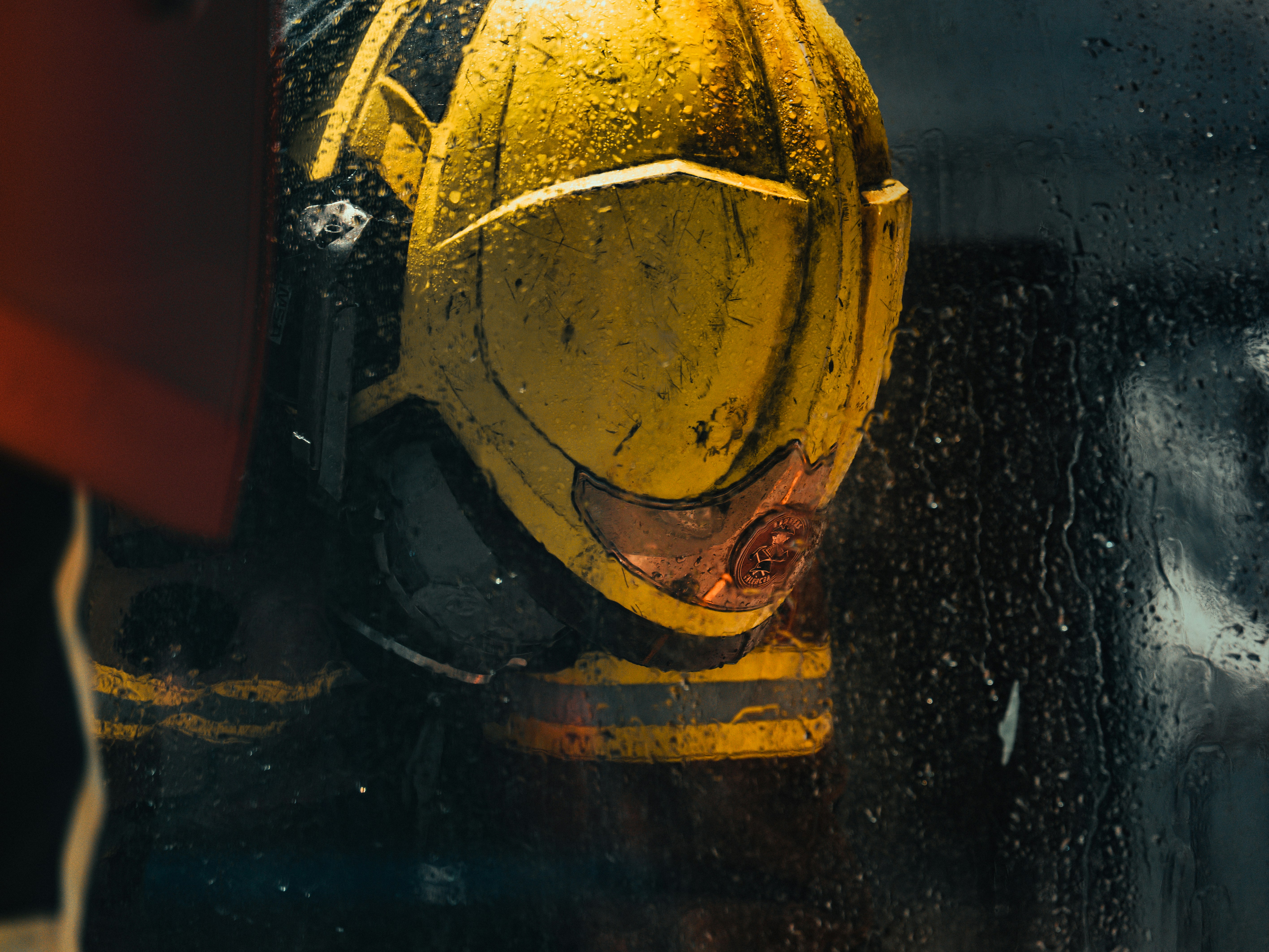 Close-up of a weathered yellow helmet with red accents