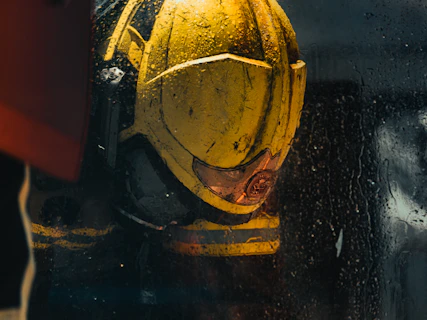 Close-up of a weathered yellow helmet with red accents