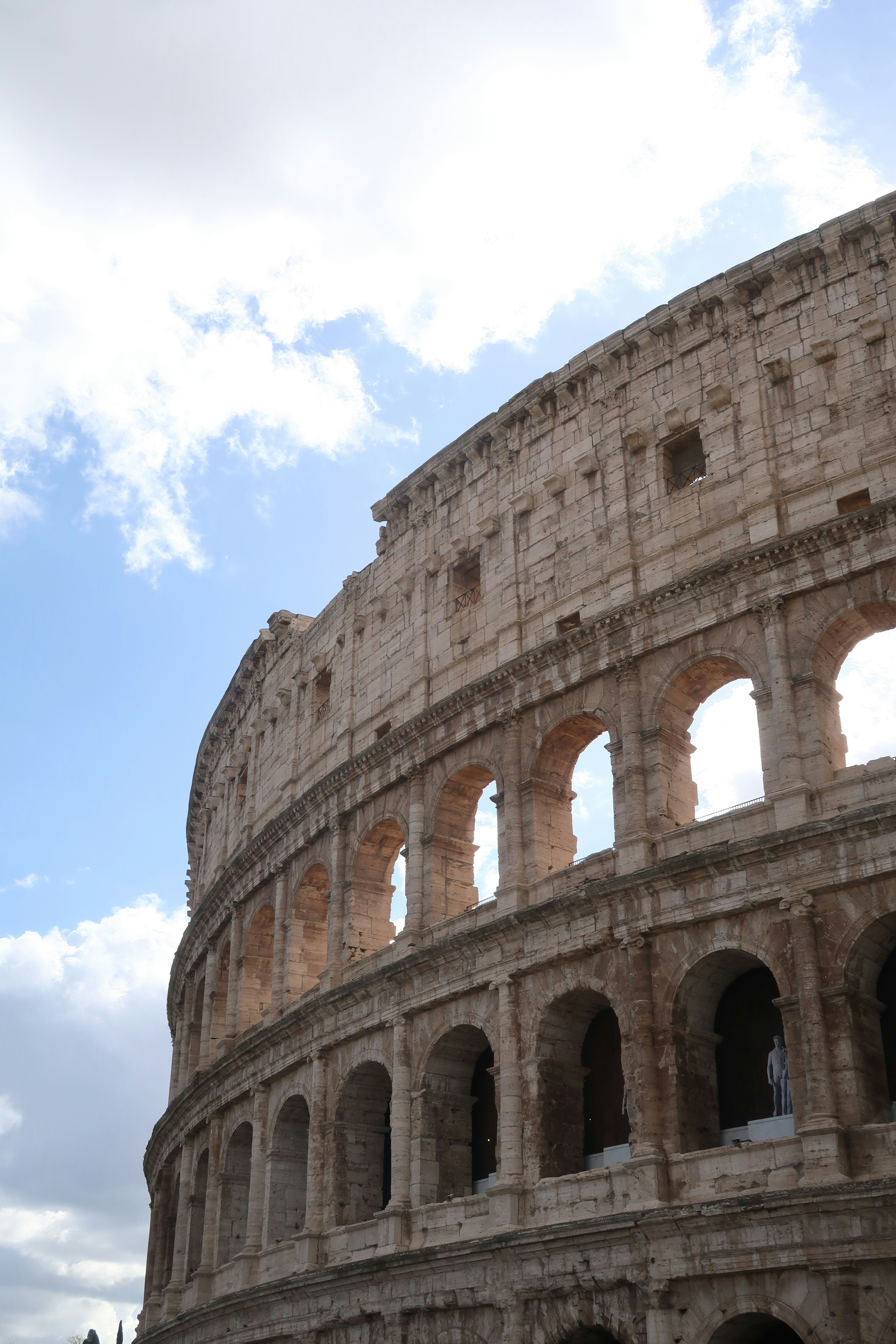 The colosseum in rome under a cloudy sky