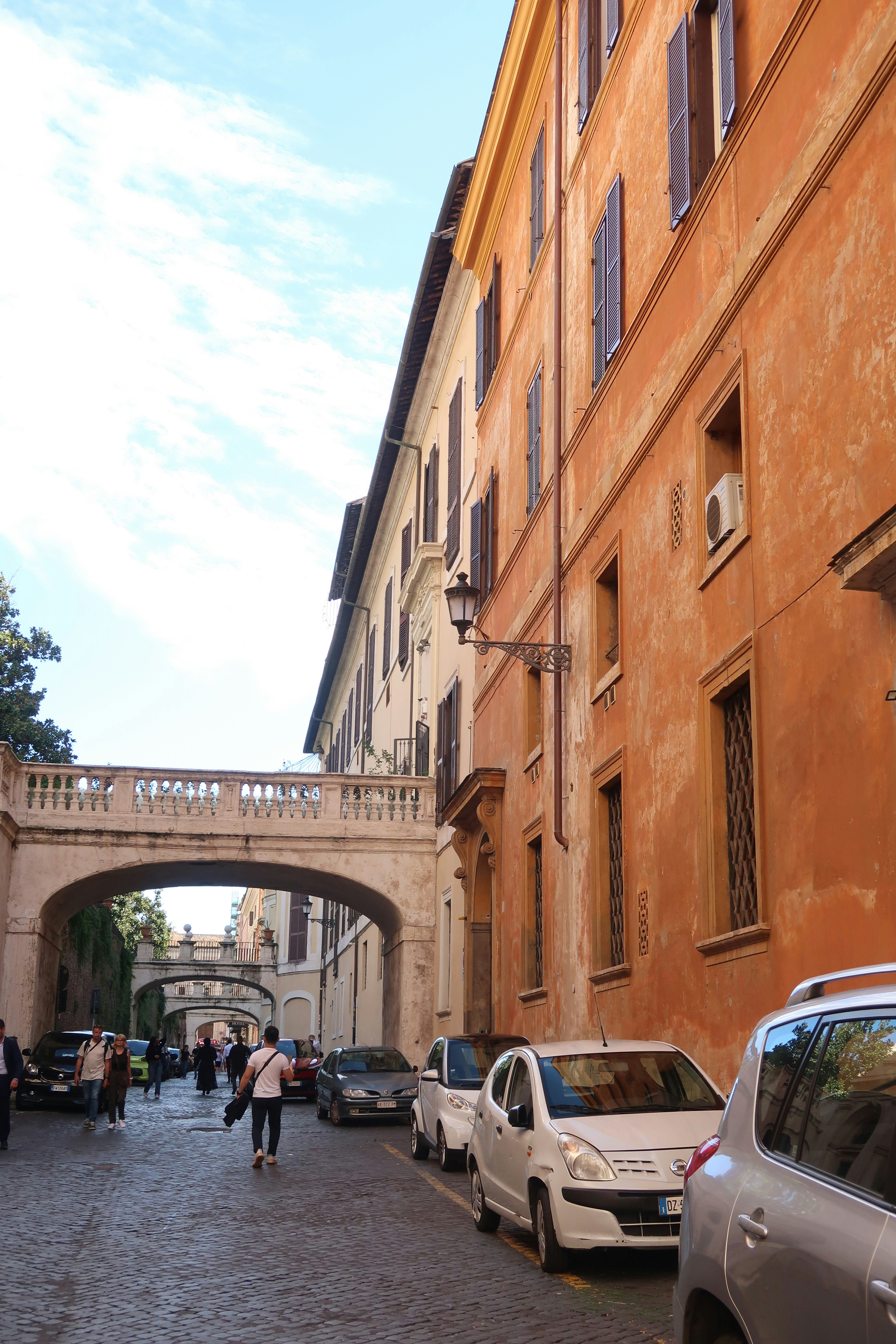 Street scene with arched bridge and parked cars
