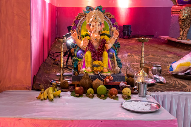 Ganesha idol on a decorated altar with fruits and puja offerings