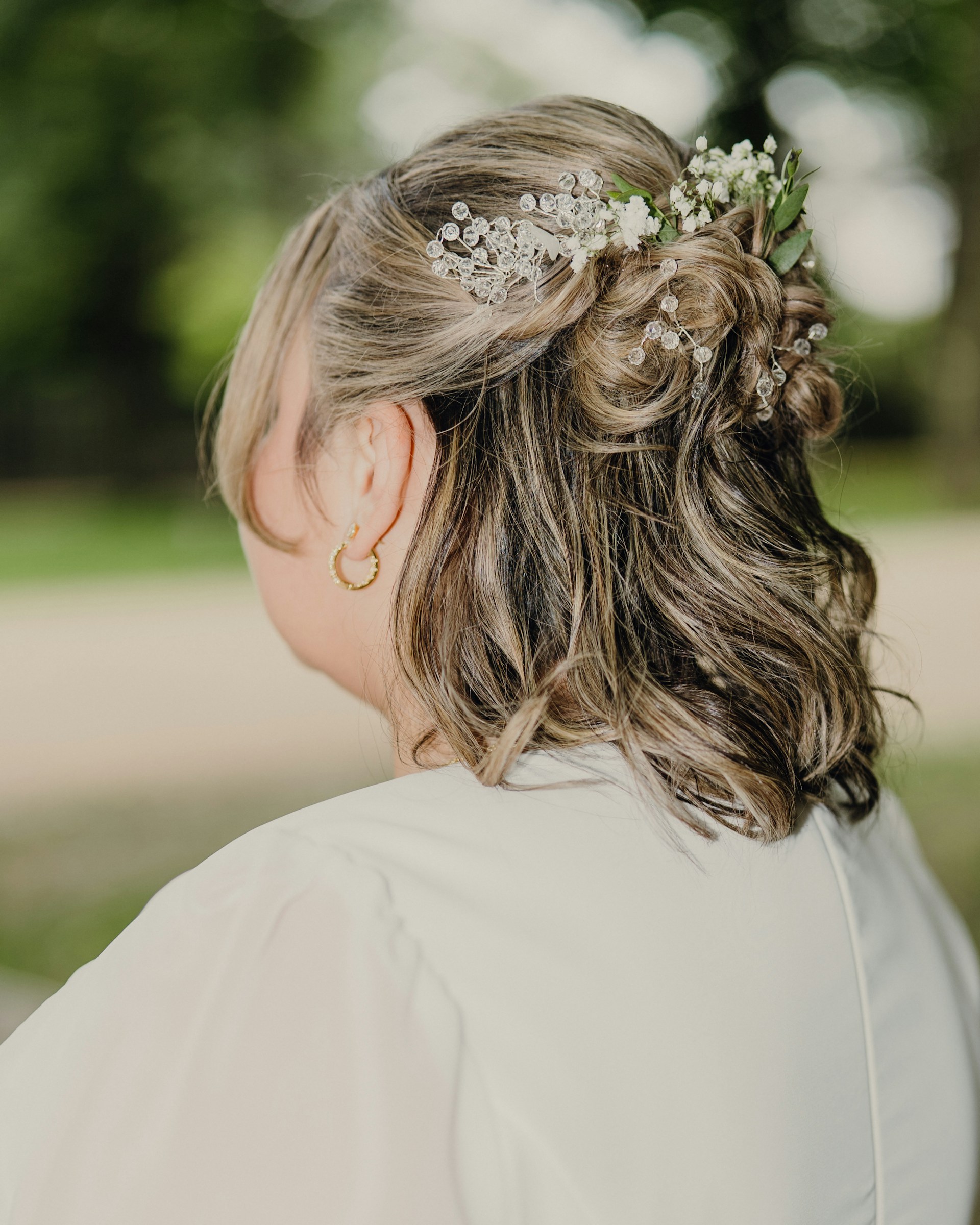 Woman with floral hair accessory and gold earring