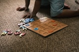 Child playing with alphabet puzzle on carpet