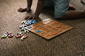 Child playing with alphabet puzzle on carpet